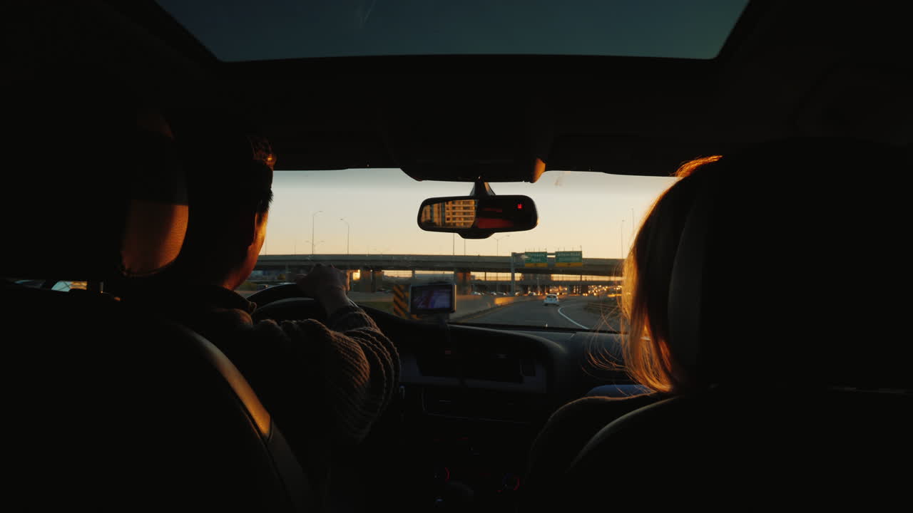 Couple Driving Car at Sunset