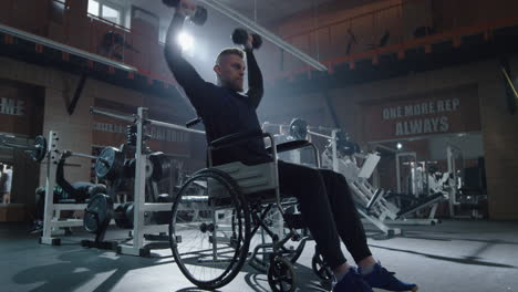 man in wheelchair lifting weights at gym confident man in wheelchair performs shoulder press exercise with dumbbells at modern gym demonstrating strength fitness and determination