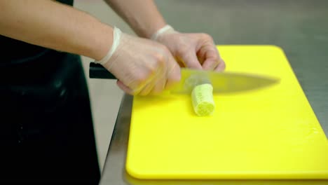 cu cook very quickly cuts a fresh cucumber into round slices with a knife