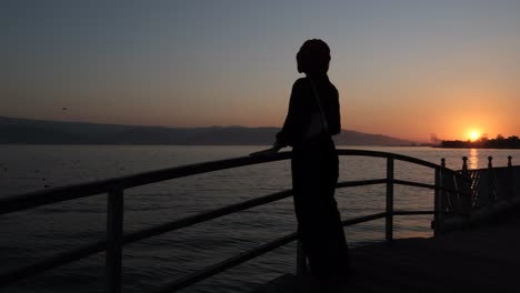 silhouette of woman strolling sunset