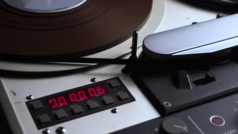 counter and reel to reel tape spinning on professional magnetophone player recorder