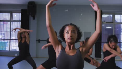 Multi-ethnic-group-of-fit-female-modern-dancers-practicing-a-dance-routine