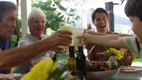 family eating outside together in summer