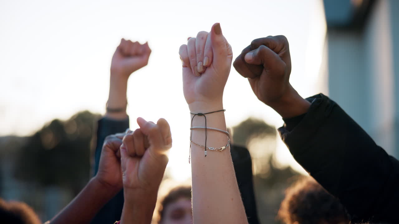 Group of People Raising Fists in Protest