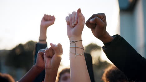 group of people raising fists in protest
