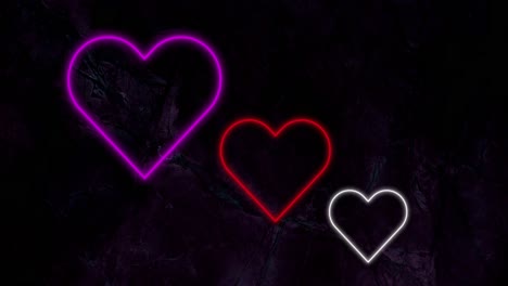 animación de corazones de neón rojo y blanco rosado que parpadean sobre un fondo negro