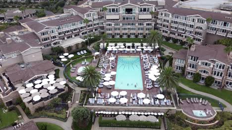 aerial pan up of fancy beachside montage resort in laguna beach, california