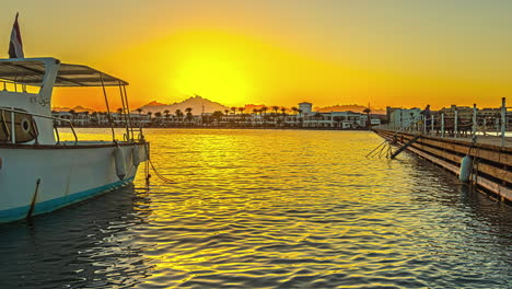 Moored-boat-and-sunrise-above-tropical-cityscape,-fusion-time-lapse