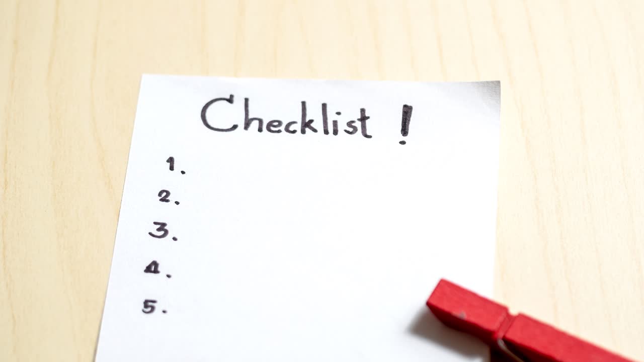 A close-up view of a blank checklist in an office emphasizing the importance of organization and planning.