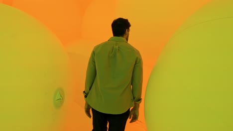 A mesmerizing scene of a man walking through the enchanting light installations at TeamLab Planets in Tokyo.