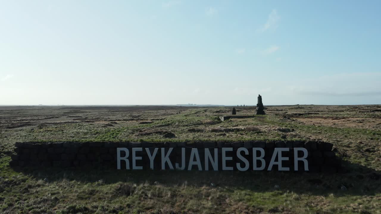 Reykjanesbær sign on top of hill in Iceland on sunny day, aerial