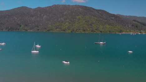 slowmo - aerial shot of sail boats in queen charlotte sound, marlborough sounds, south island, new zealand