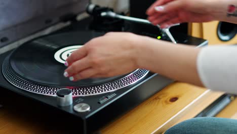 woman turns off the turntable takes the lp