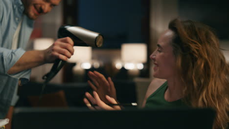 Couple-having-fun-home-night-closeup.-Funny-husband-distracting-wife-at-evening