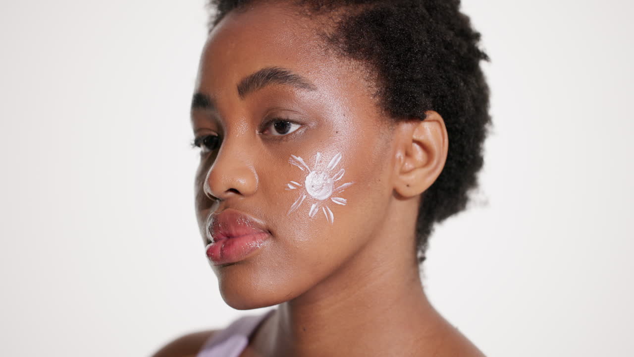 Woman with Sunscreen Sun Drawing on Face