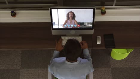 Overhead-view-of-man-having-a-video-conference-