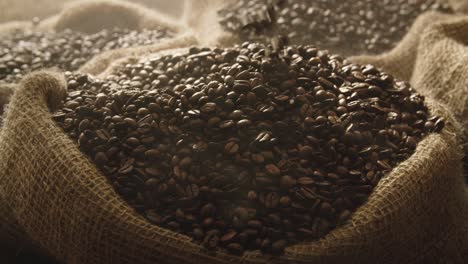 wooden ladle picking up freshly roasted coffee beans, medium close up, falling back into coarse linen sack in warehouse, warm lighting atmosphere