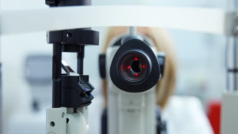 patient checking vision with equipment. doctor optometrist examining with special eye equipment