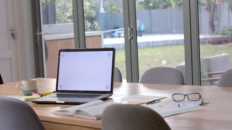 Laptop with copy space on screen on table at home, slow motion