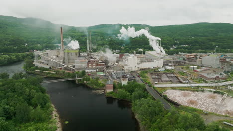 aerial view of rumford maine paper mill with androscoggin river and smoking stacks