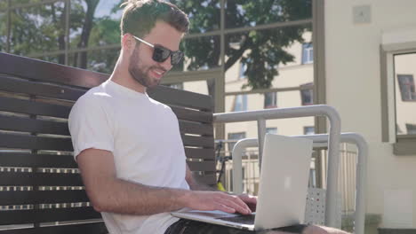 man working on laptop outdoors