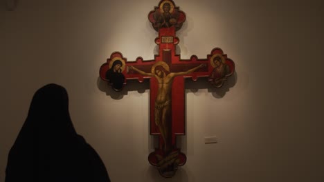 a beautiful shot, a nun in the church in front of the cross