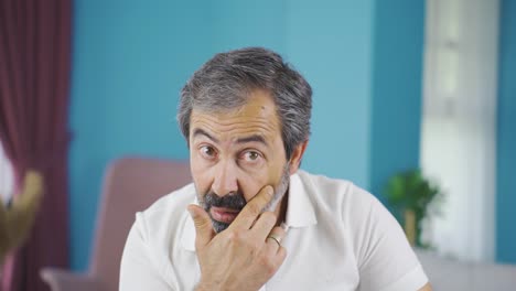 middle-aged man bothered by wrinkles on his face.