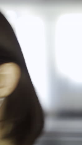 woman wearing a mask having her temperature checked