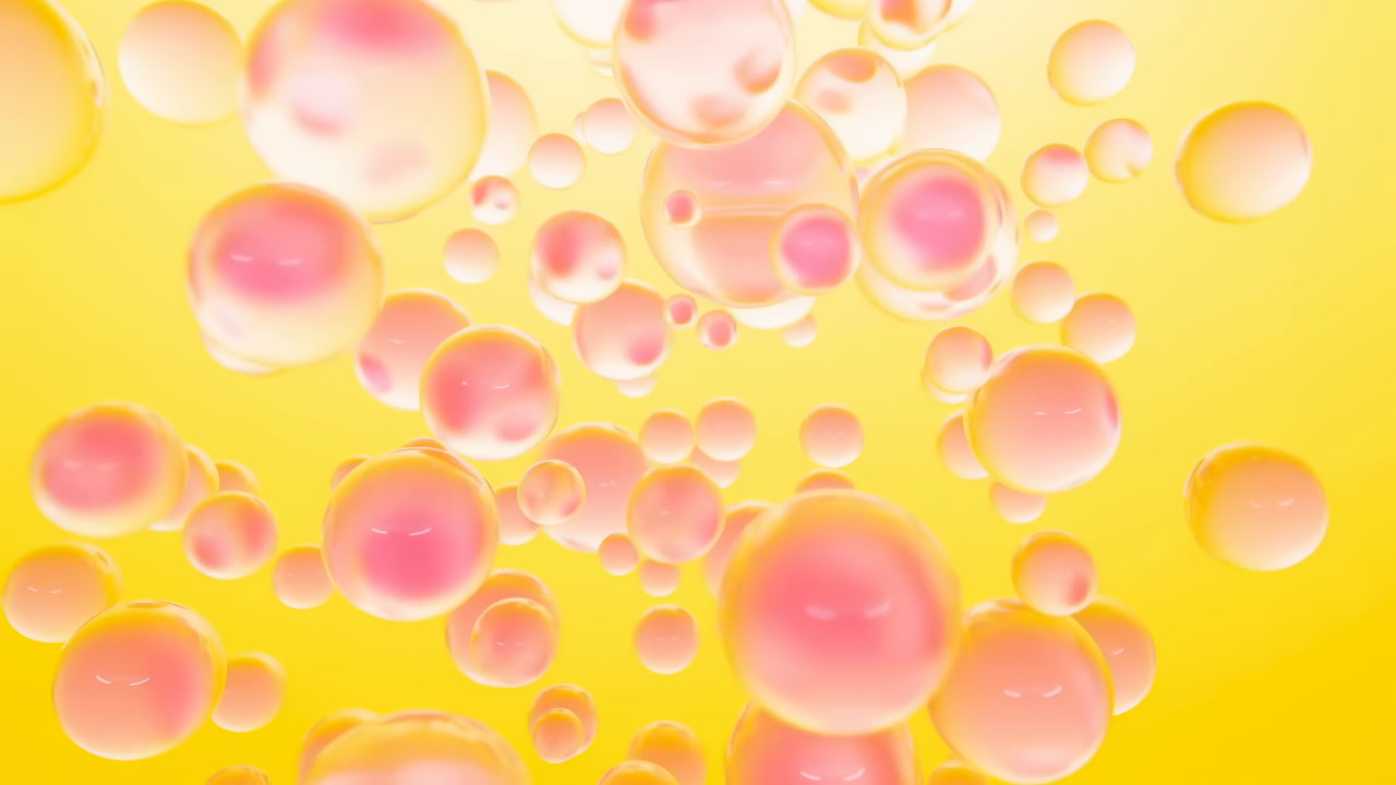 Pink Bubbles Floating On Vivid Yellow, Macro Studio Sequence Shows Glossy Pink Spheres Of Varying Sizes Rising