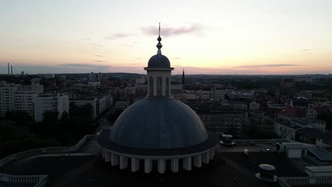 archcathedral of christ the king during sunset with cityscape all around