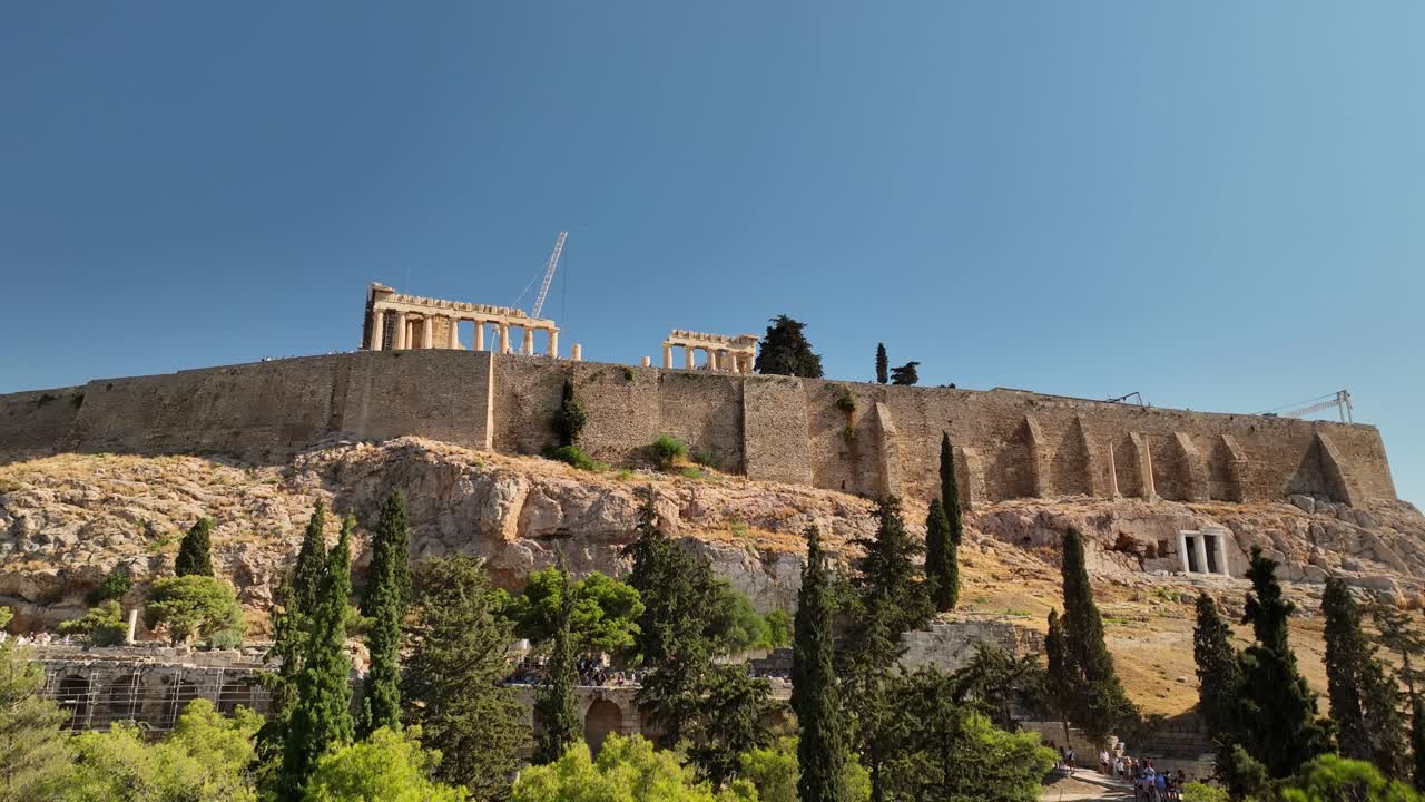 UHD Athens city skyline drone, featuring the Acropolis, Parthenon, and nearby archaeological sites in crisp daylight for tourism and history projects.