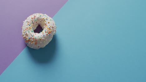 Video-of-donuts-with-icing-on-blue-and-purple-background