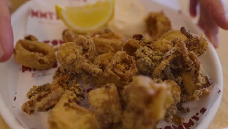 a plate of fried calamari with lemon