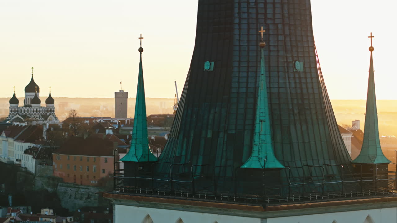Aerial view of Tallinn old town with Oleviste church tower in foreground and Stenbock government building in beautiful summer sunset