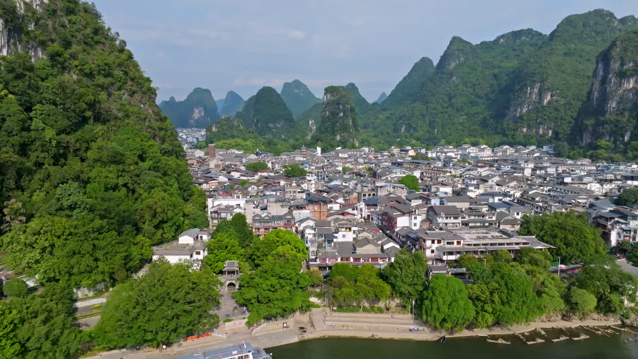 Aerial tracking shot in front of the Yangshou town, sunny, summer day in China