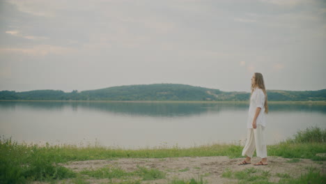 sad contemplative woman by the lake