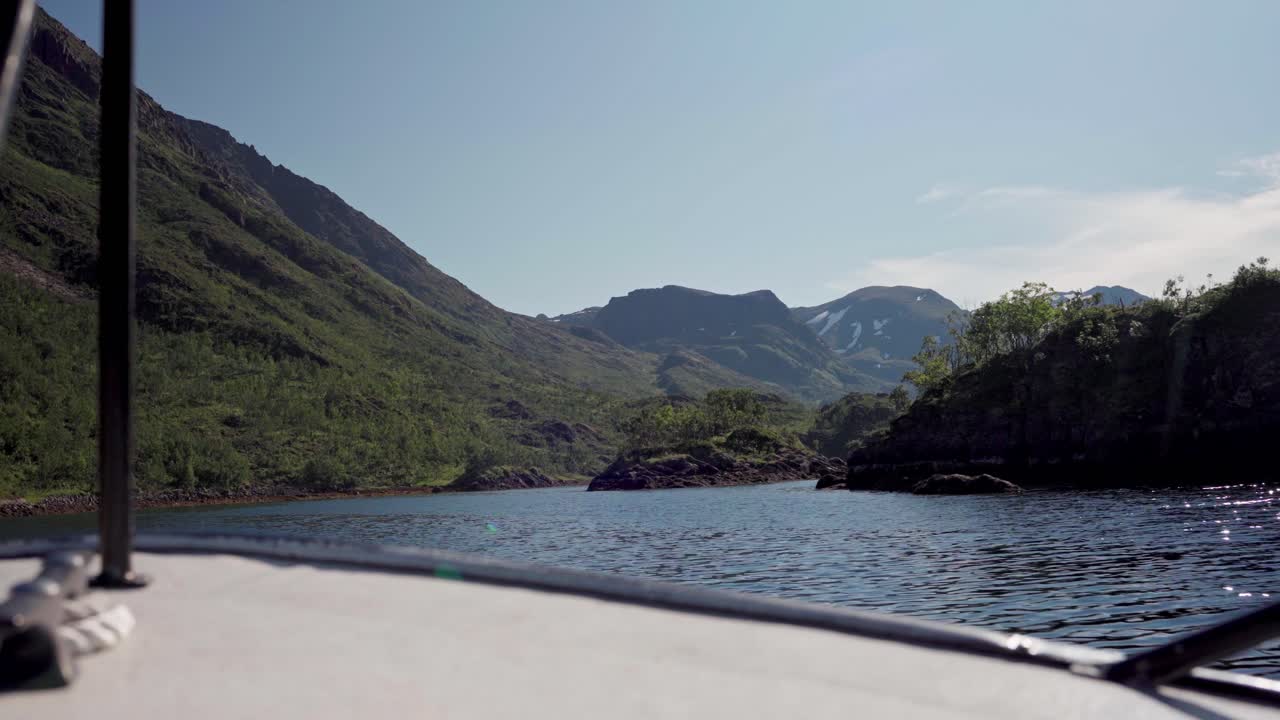 Traveling by boat through a lake and green mountains of Norway - Wide