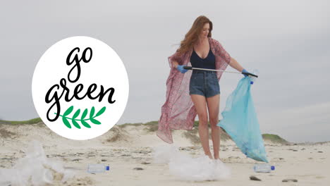 animation of go green text and logo over smiling caucasian woman picking up rubbish from beach