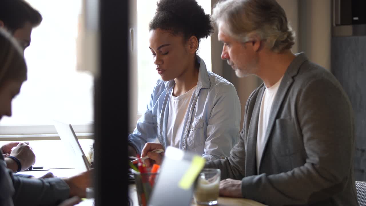 The creative team is discussing a new project. Casual young people in new creative business office.