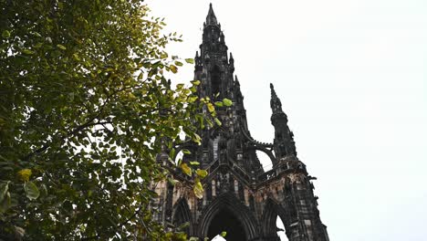 scott monument's victorian gothic spire and pinnacles, behind a tree