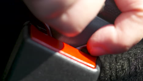 close up of a car seatbelt being buckled