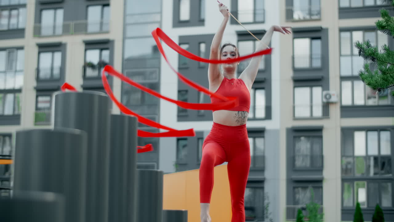 Woman Performing Ribbon Dance in Urban Setting