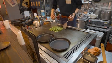 japanese chef grilling edamame. slowed to half speed