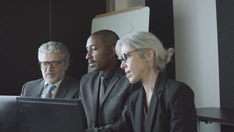 diverse office colleagues meeting and talking at workplace