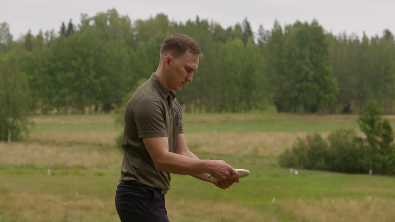 Disc golfer warming up to putt