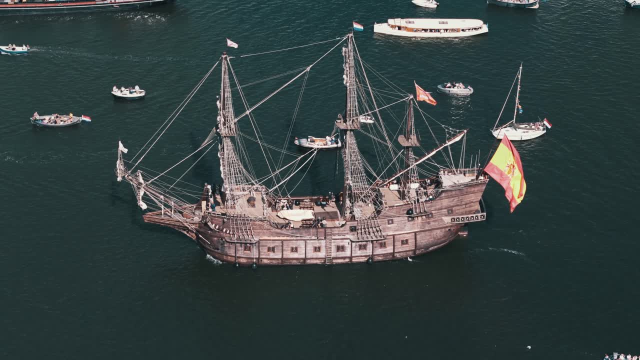 Circling a towering Spanish tall ship as it sails in grandeur