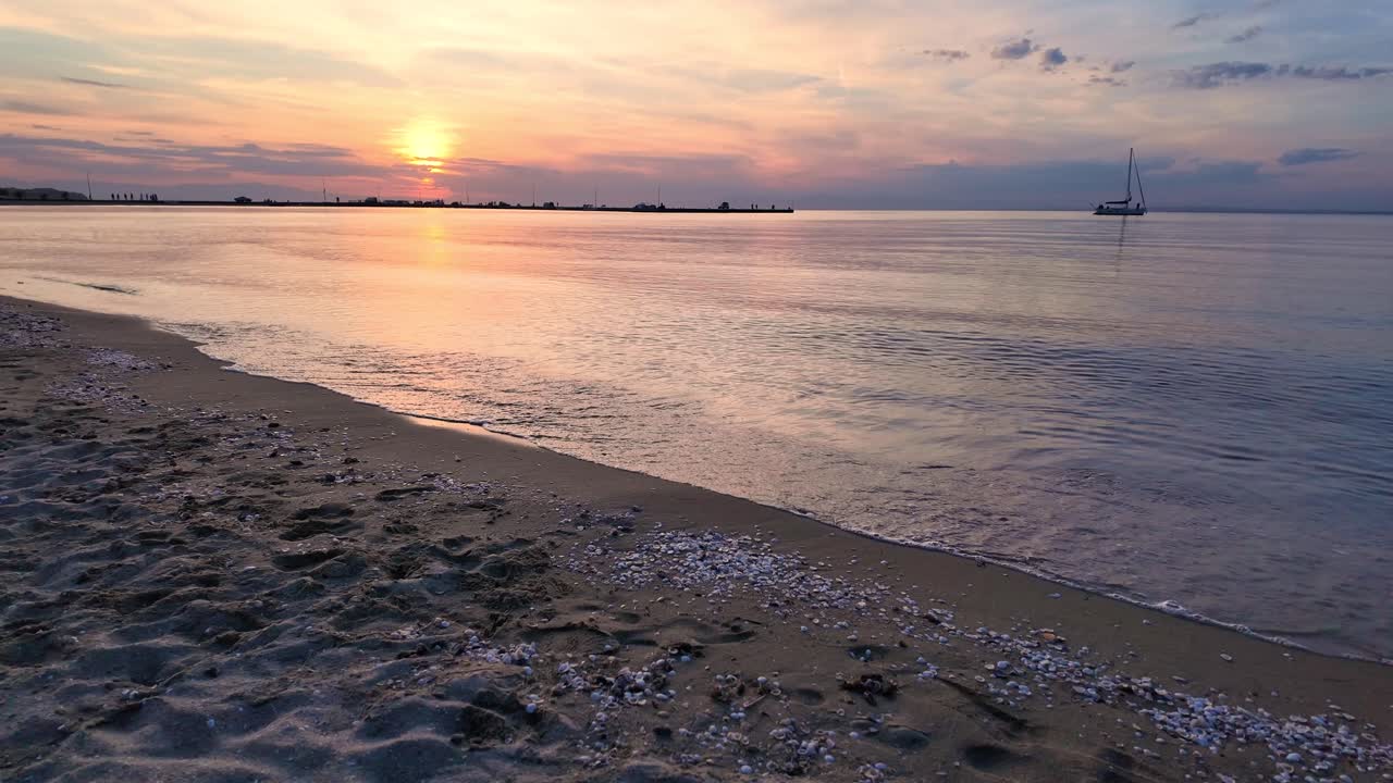 Beautiful sunset at beach, sun reflection sea ocean water Peraia Greece holiday destination