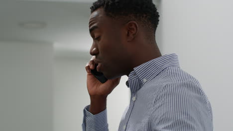 young businessman in office talking on mobile phone reacting to bad news looking unhappy and depressed 6