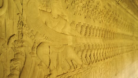 sculpture carving bas-relief along the east side temple wall of  angkor wat.  it depects people pulling on a snake in hopes for eternal life, siem reap, cambodia