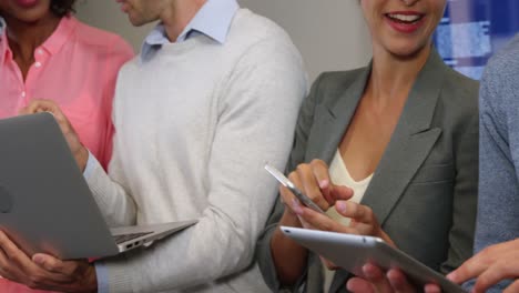 businesspeople interacting over a laptop, digital tablet and mobile phone